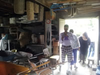 Workroom with Pola Stout's baskets hanging from the rafters.