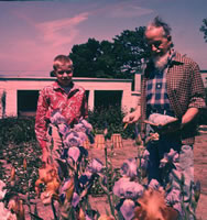 REX STOUT with young visitor in his garden